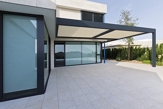 PÉRGOLA BIOCLIMÁTICA PROTEGIENDO LA TERRAZA DE UNA VIVIENDA EN URBANIZACIÓN DE LUJO